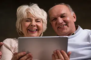 A couple watching a video on a tablet.